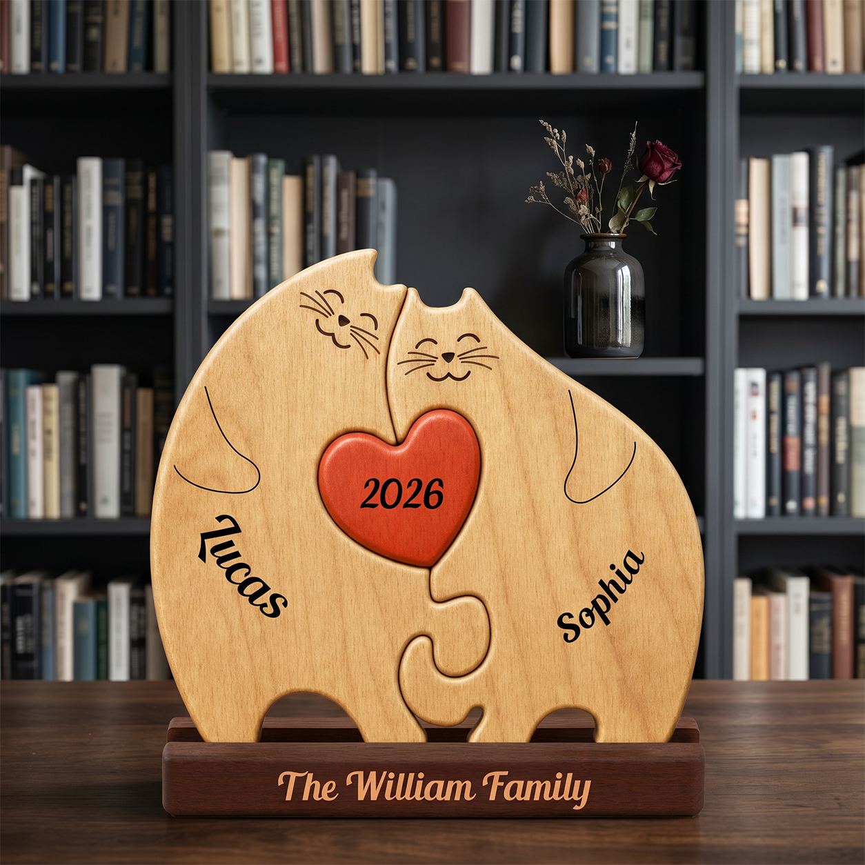 A wooden puzzle plaque shaped like two cat heads with a red heart in the center, engraved with the names