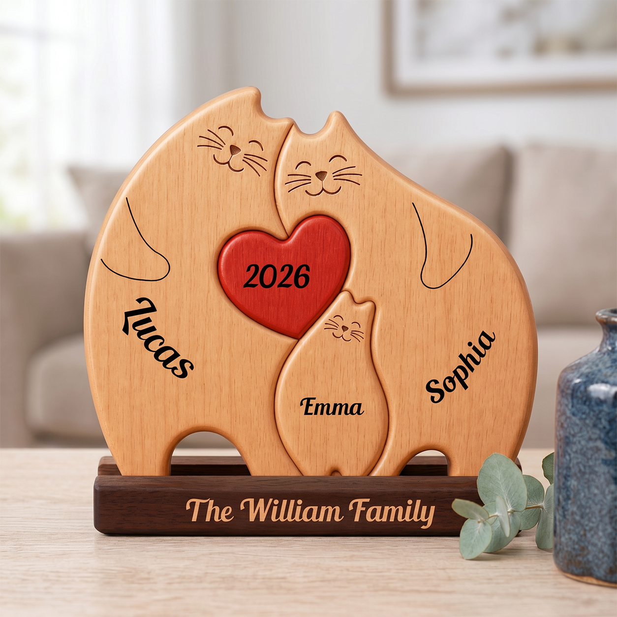 Personalized wooden cat-shaped plaque on a dark base, engraved with three smiling cats, a red heart in the center reading 2026
