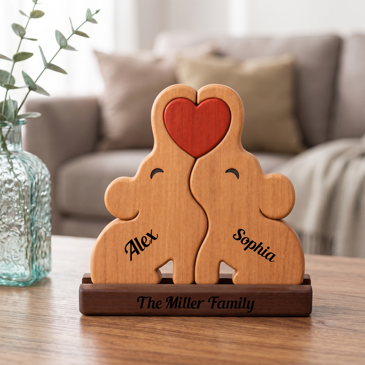 Wooden puzzle sculpture of two bears with a heart, engraved with names, on a table.