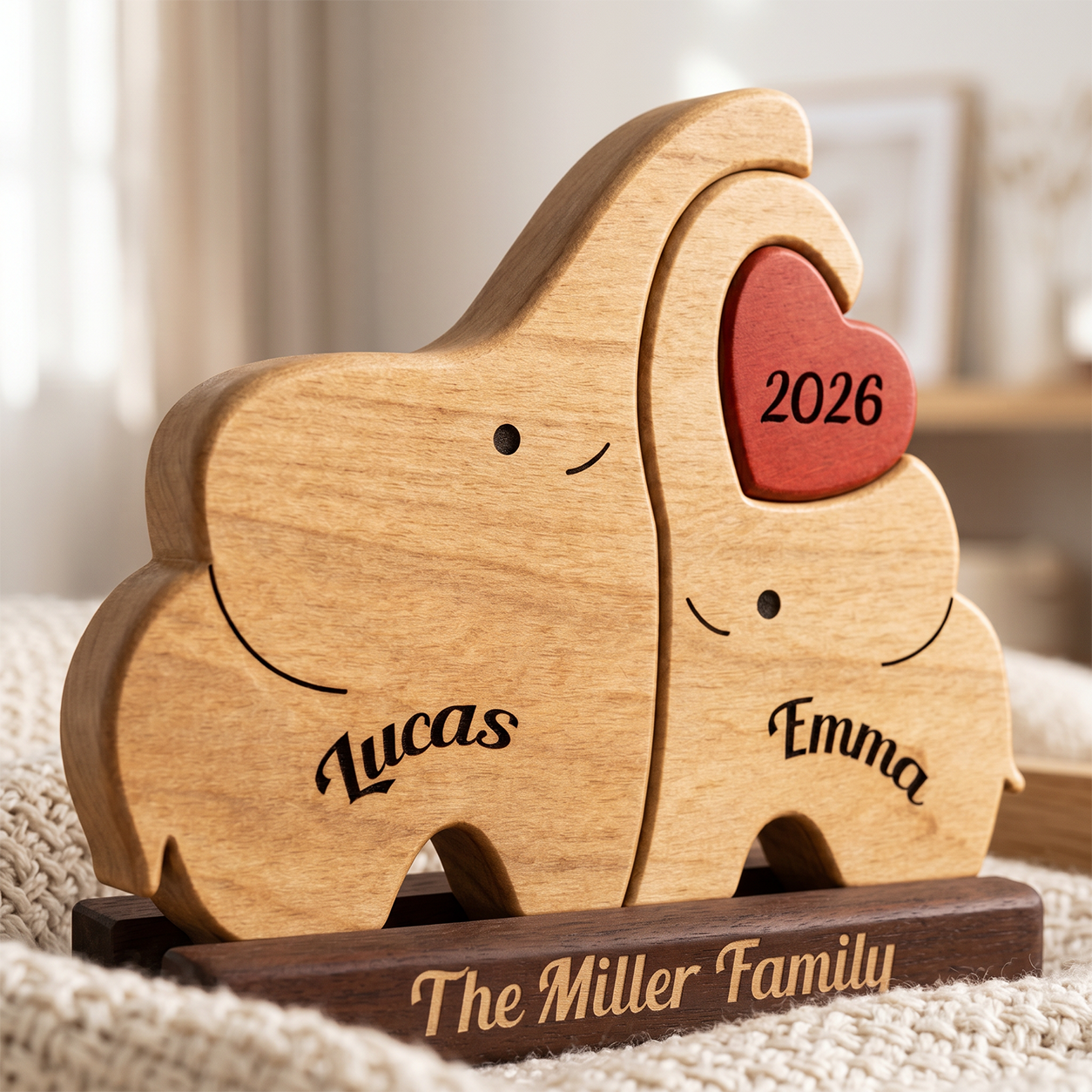 Personalized wooden elephant puzzle toy with engraved faces and names , and a dark base engraved 'The Family Name', shown on a soft neutral background.