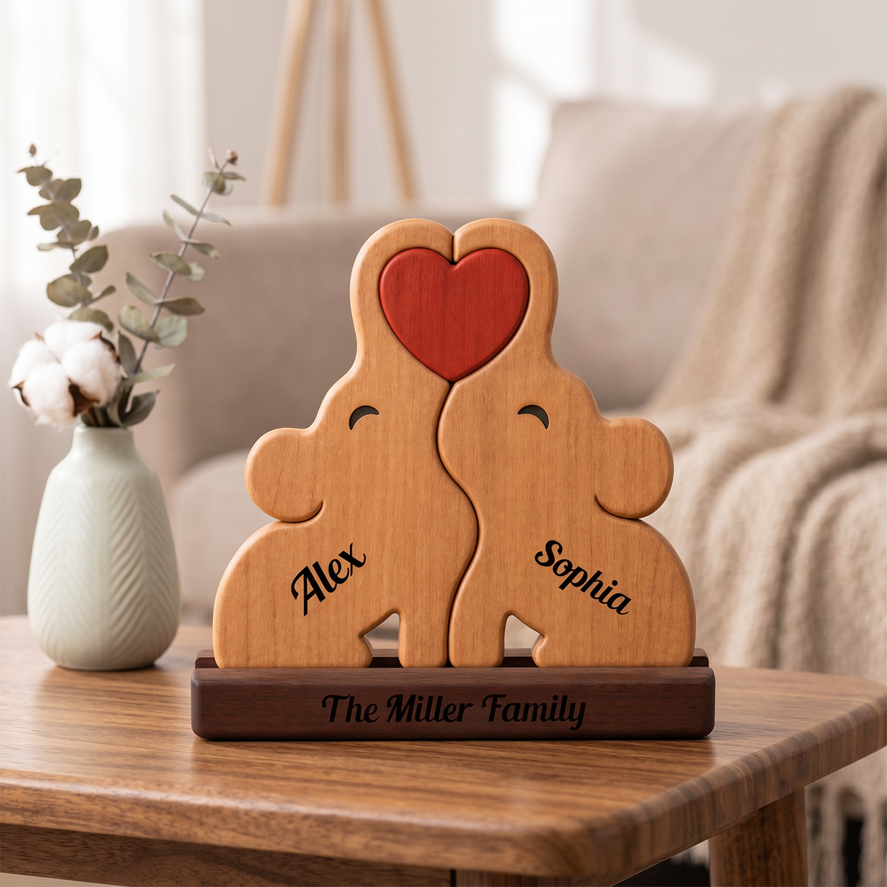 Wooden Elephant Family Wooden-shaped decoration with hearts and engraved names on a table.