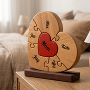 Wooden heart-shaped puzzle with engraved names on a wooden stand