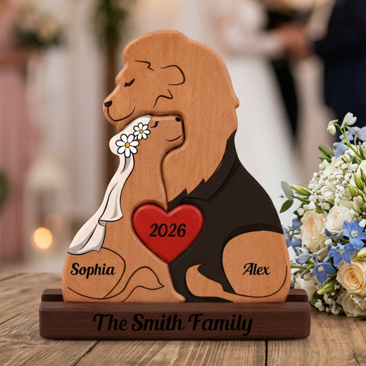 Wooden figurine of two dogs with a heart and '2026' engraved, surrounded by flowers on a wooden surface.