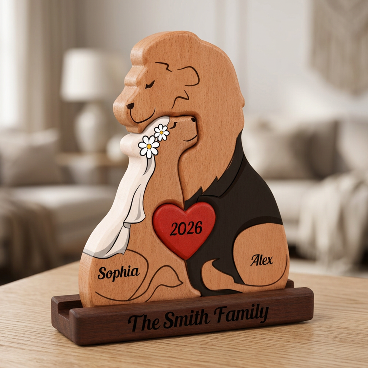 Wooden figurine of a couple with a heart and names engraved, placed on a table.