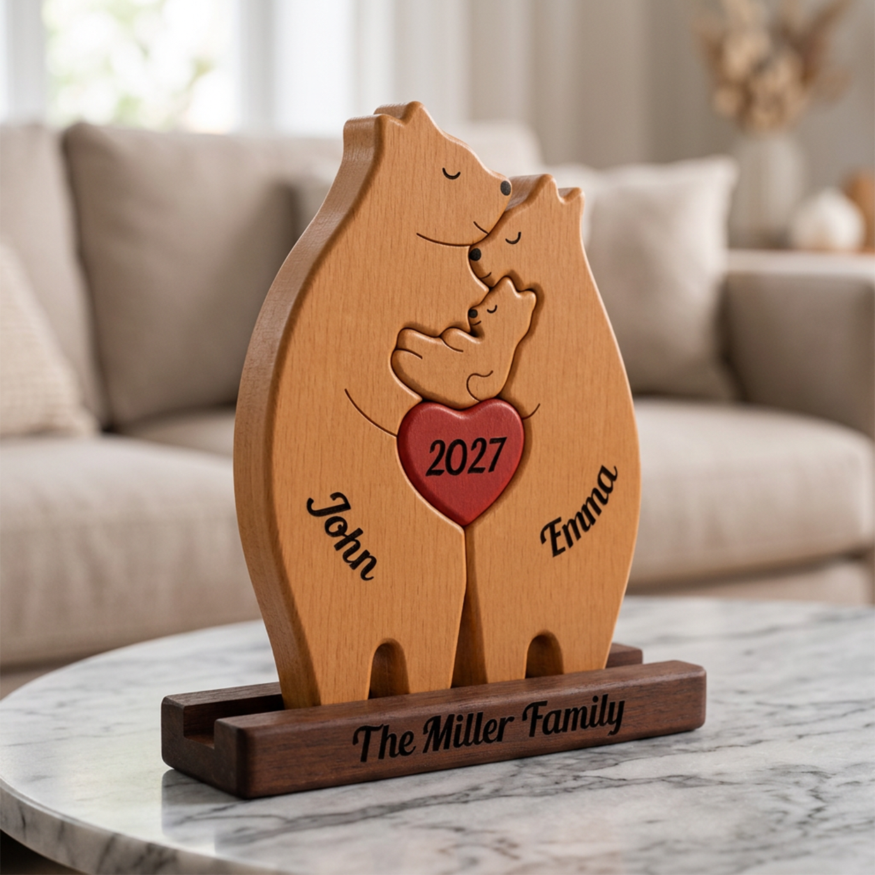 Wooden bear-shaped with '2027' and names on a marble surface