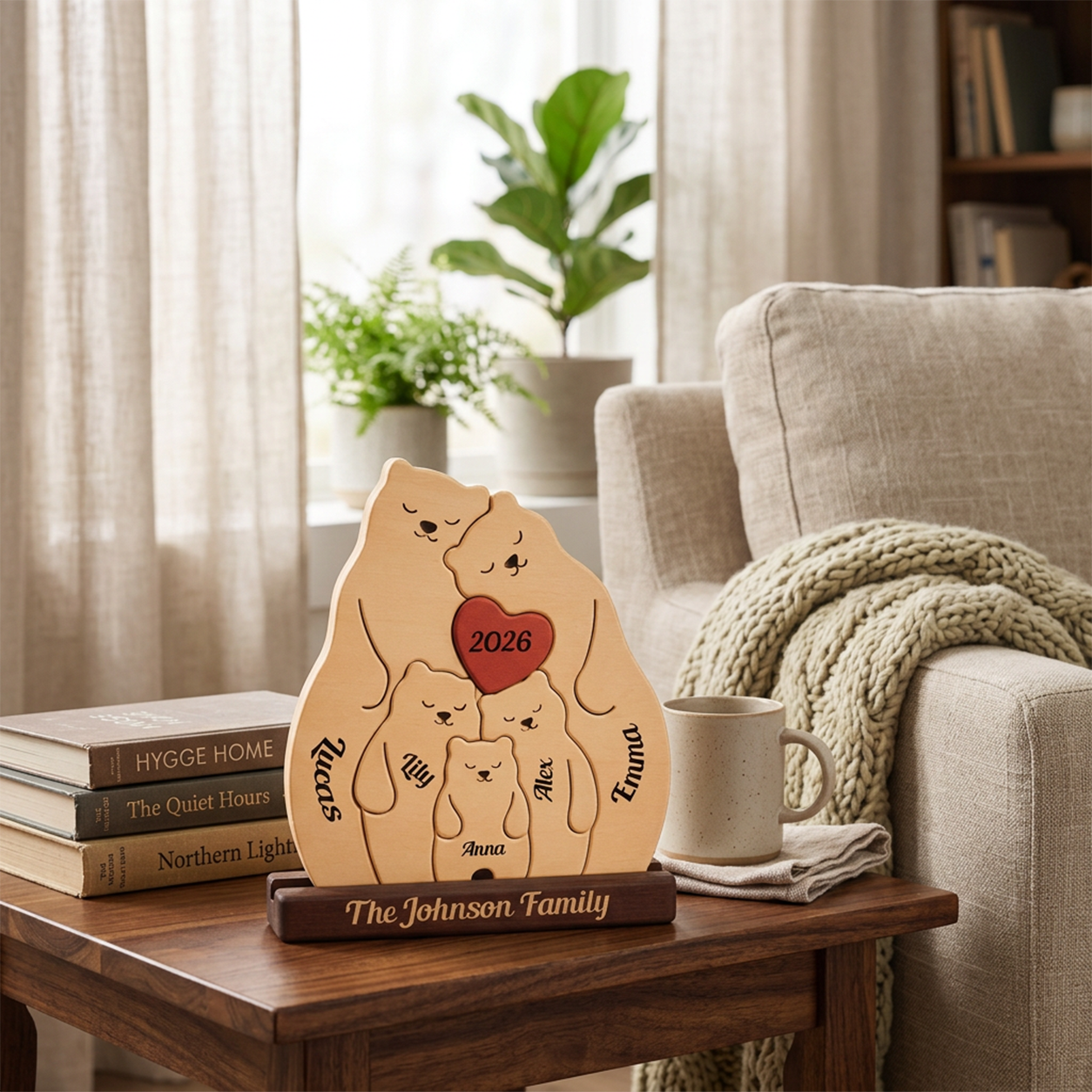 Personalized wooden family plaque on a dark base, displayed on a wooden table in a cozy living room setting next to a mug and sofa.