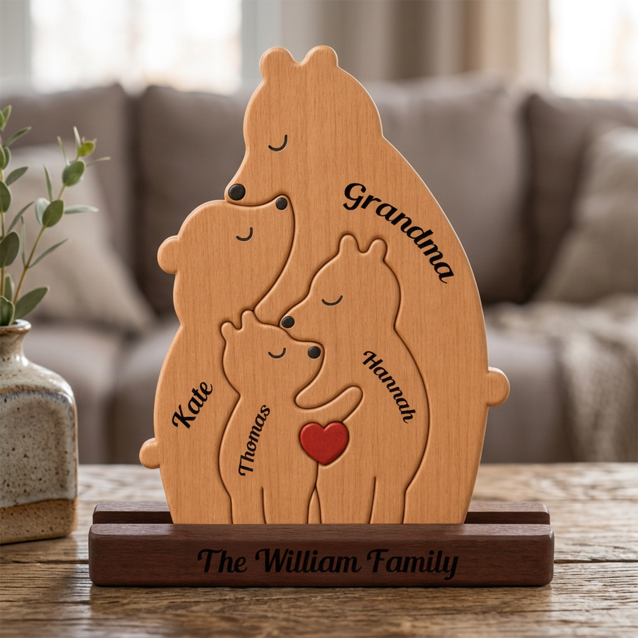 Wooden family sculpture with engraved names on a wooden stand in a living room setting.
