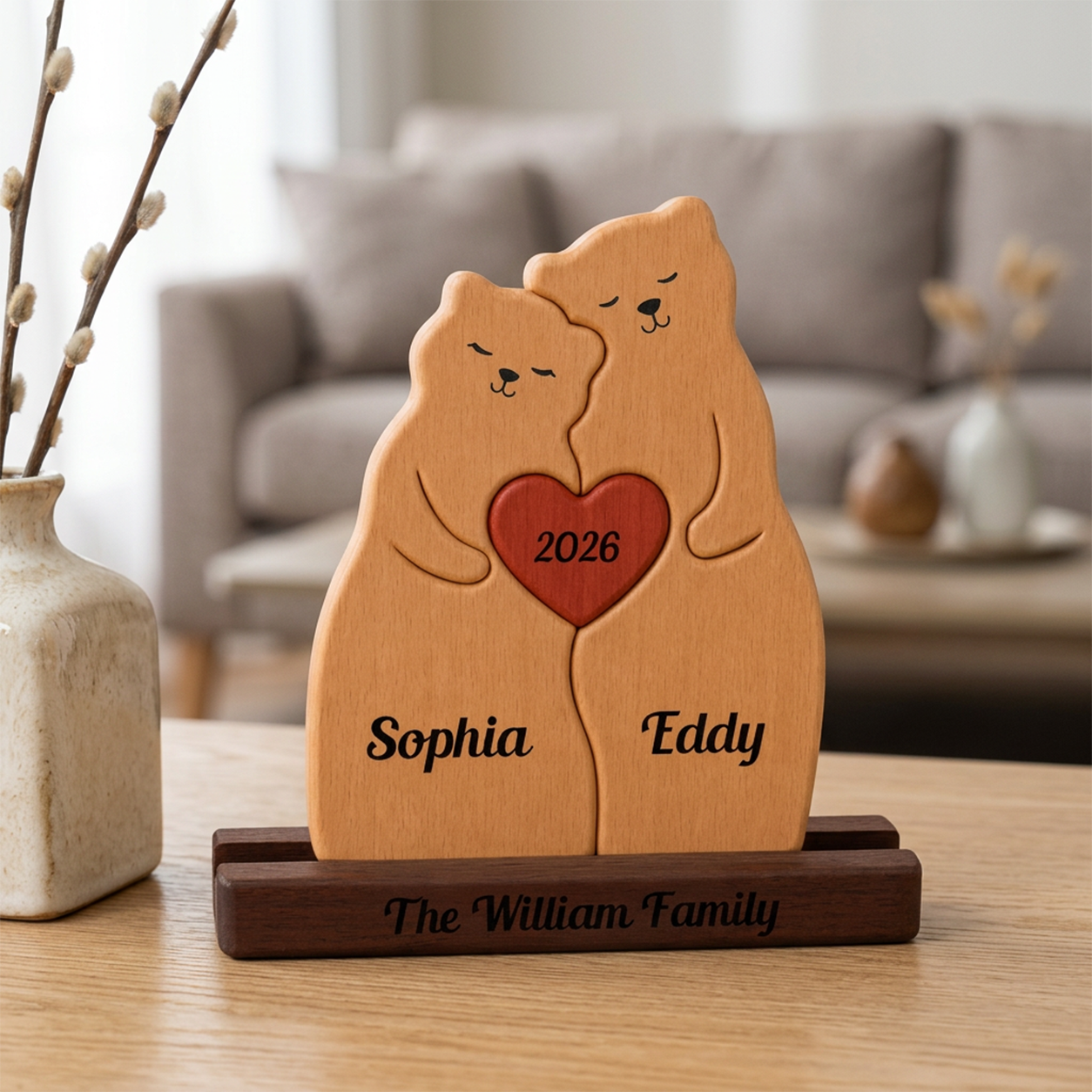 Wooden bear figurine with a heart, engraved with names and year, on a table.