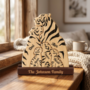 Personalized wooden family tiger plaque on a dark wood base, displayed on a wooden table in a cozy living room setting.