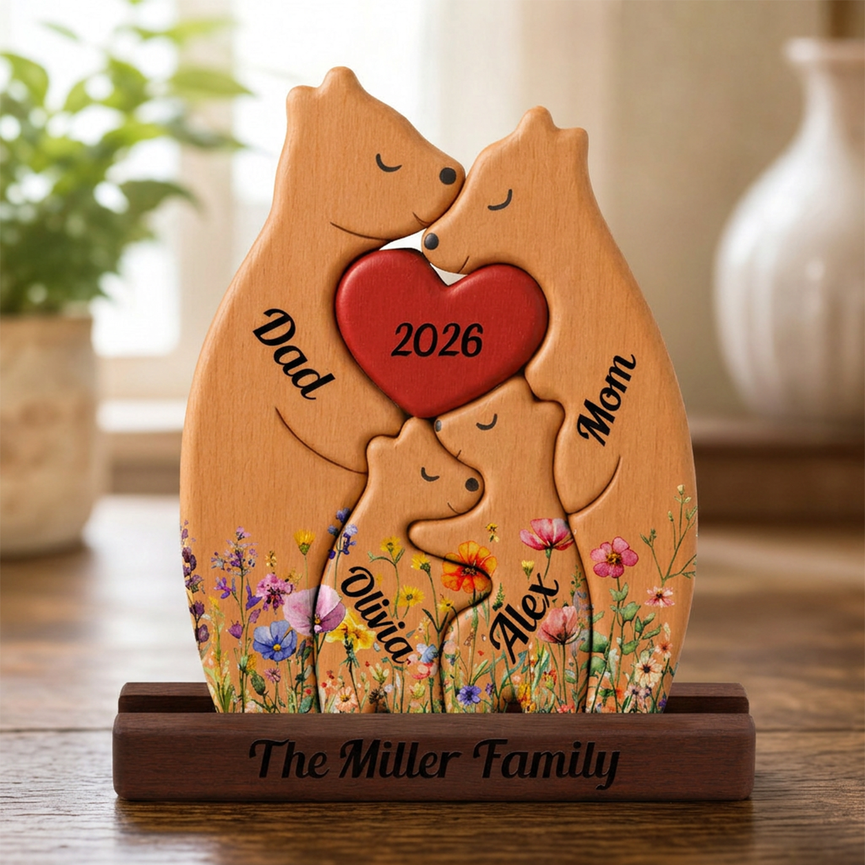 Wooden plaque with bears holding a heart, personalized with names and year, on a wooden surface.