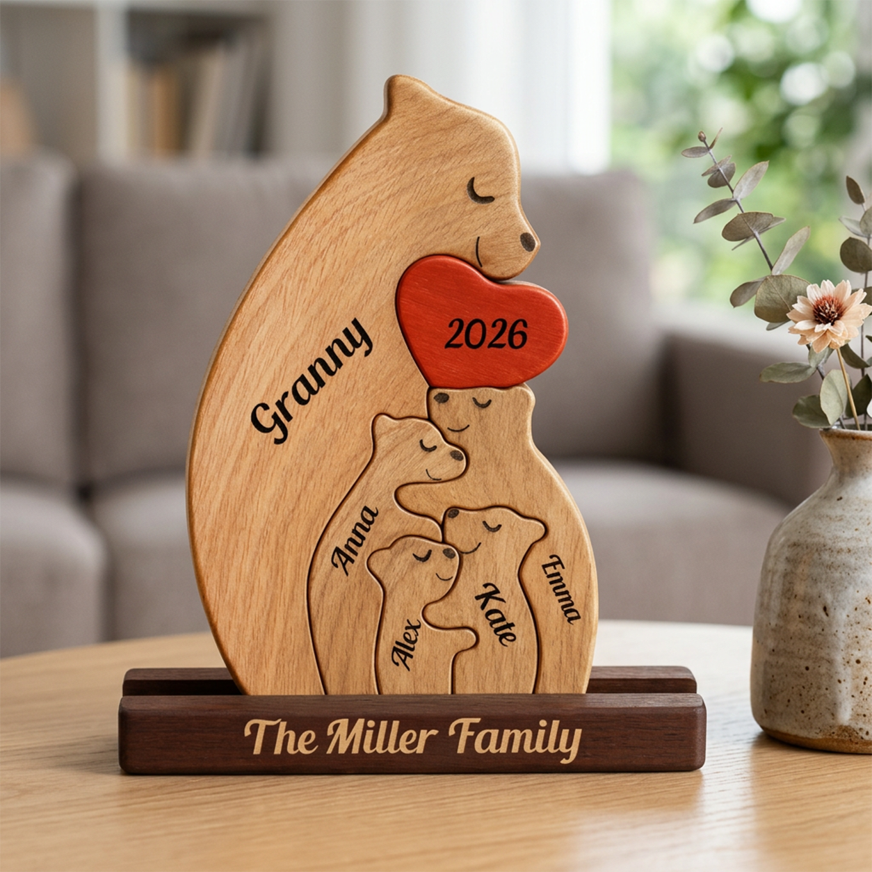 Wooden bear-shaped with engraved family names and year on a table.