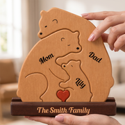 Wooden family puzzle with 'Mom', 'Dad', and 'kids' engraved, held by a hand.