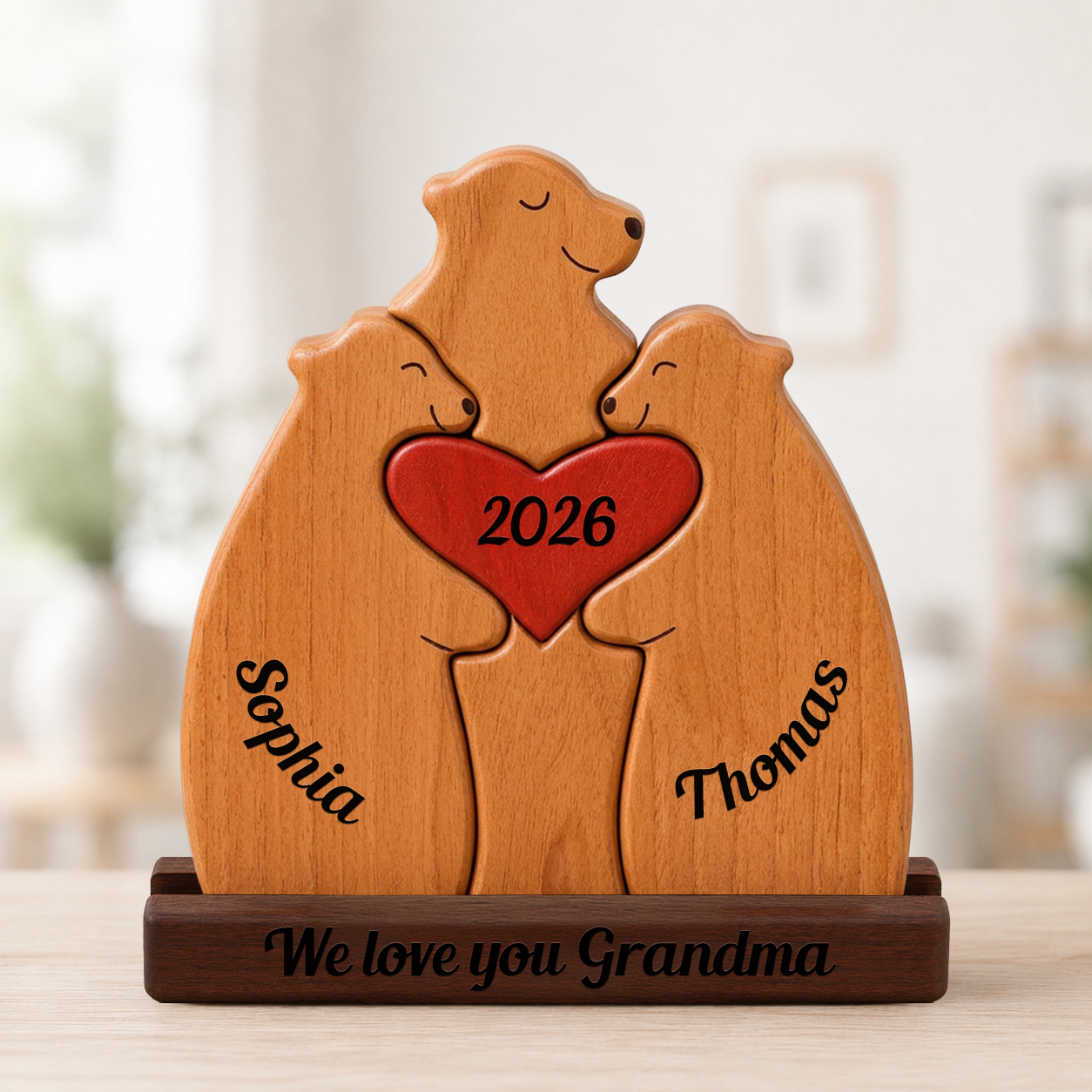 Wooden bear family figurine with a heart, engraved with names and year, on a blurred background.