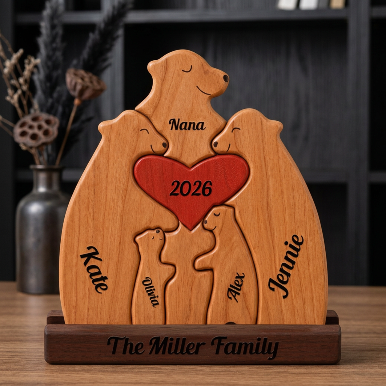 Wooden plaque with family bear design and engraved names and year, placed on a wooden surface.