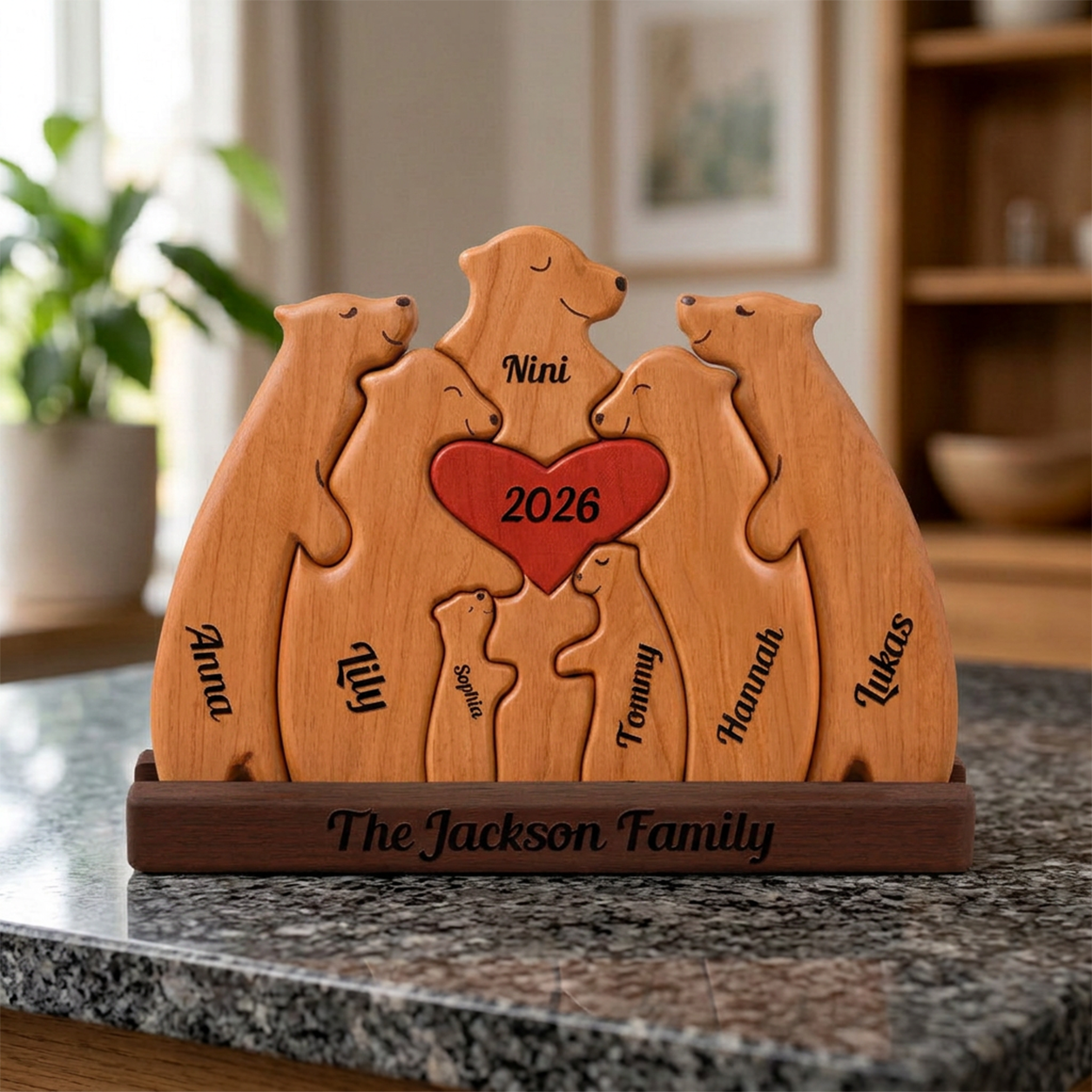 Wooden family puzzle with engraved names and year on a marble surface