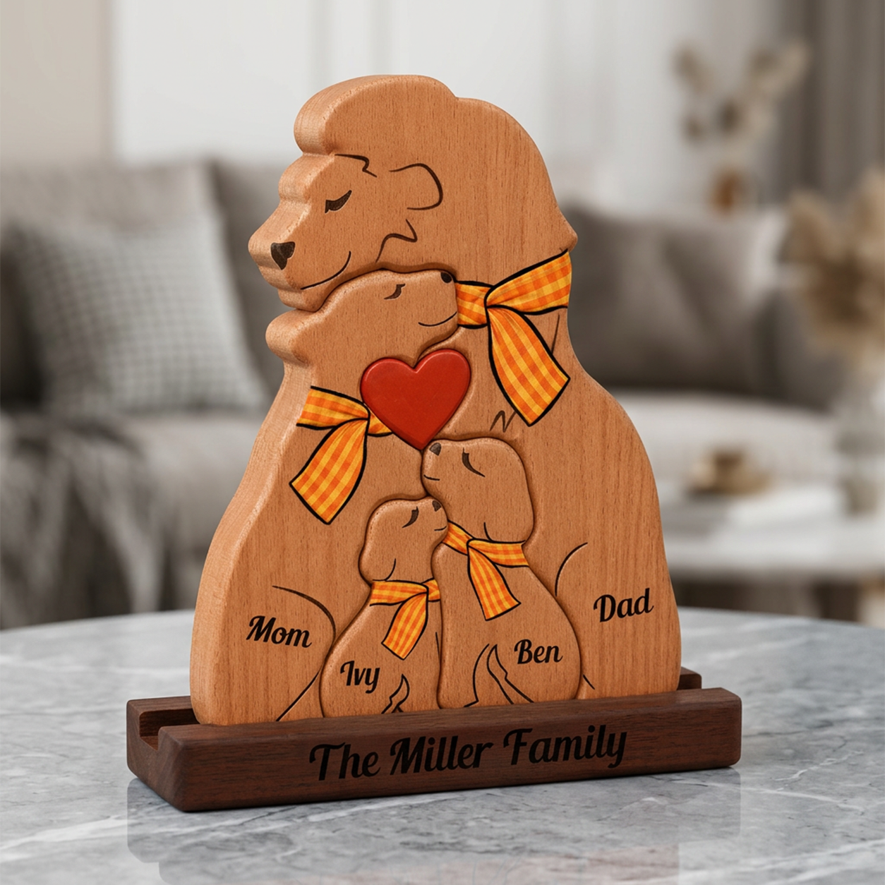 Wooden family sculpture with 'Mom', 'Dad', 'Ivy', and 'Ben' on a marble surface.