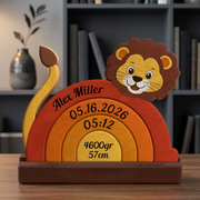 Wooden lion-shaped decoration with engraved text on a wooden base, placed on a surface with a blurred background.