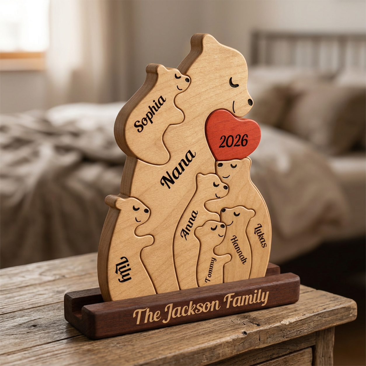 Wooden family portrait with engraved names on a wooden stand, placed on a table.