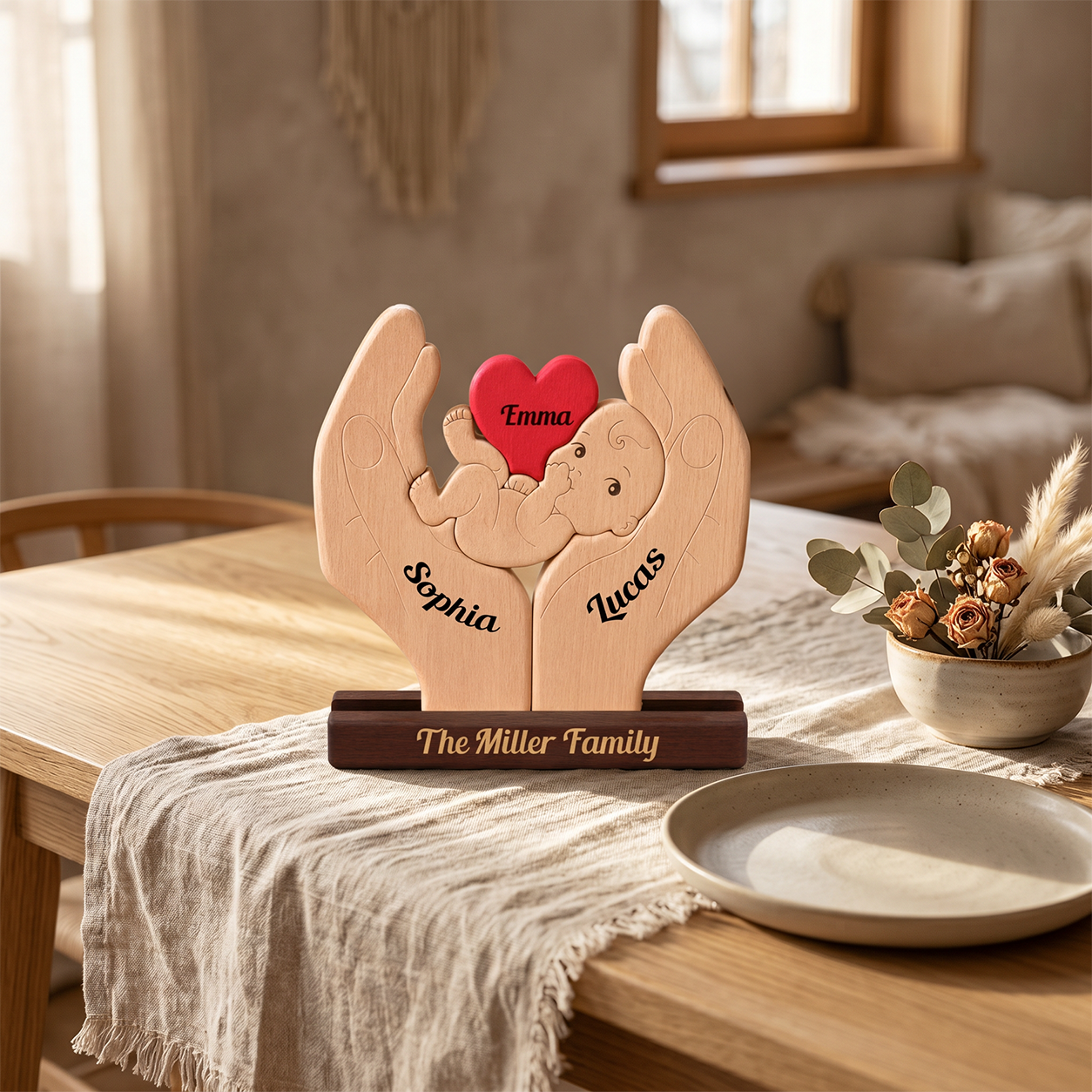Personalized wooden tabletop sculpture of two hands holding a baby, with the names 