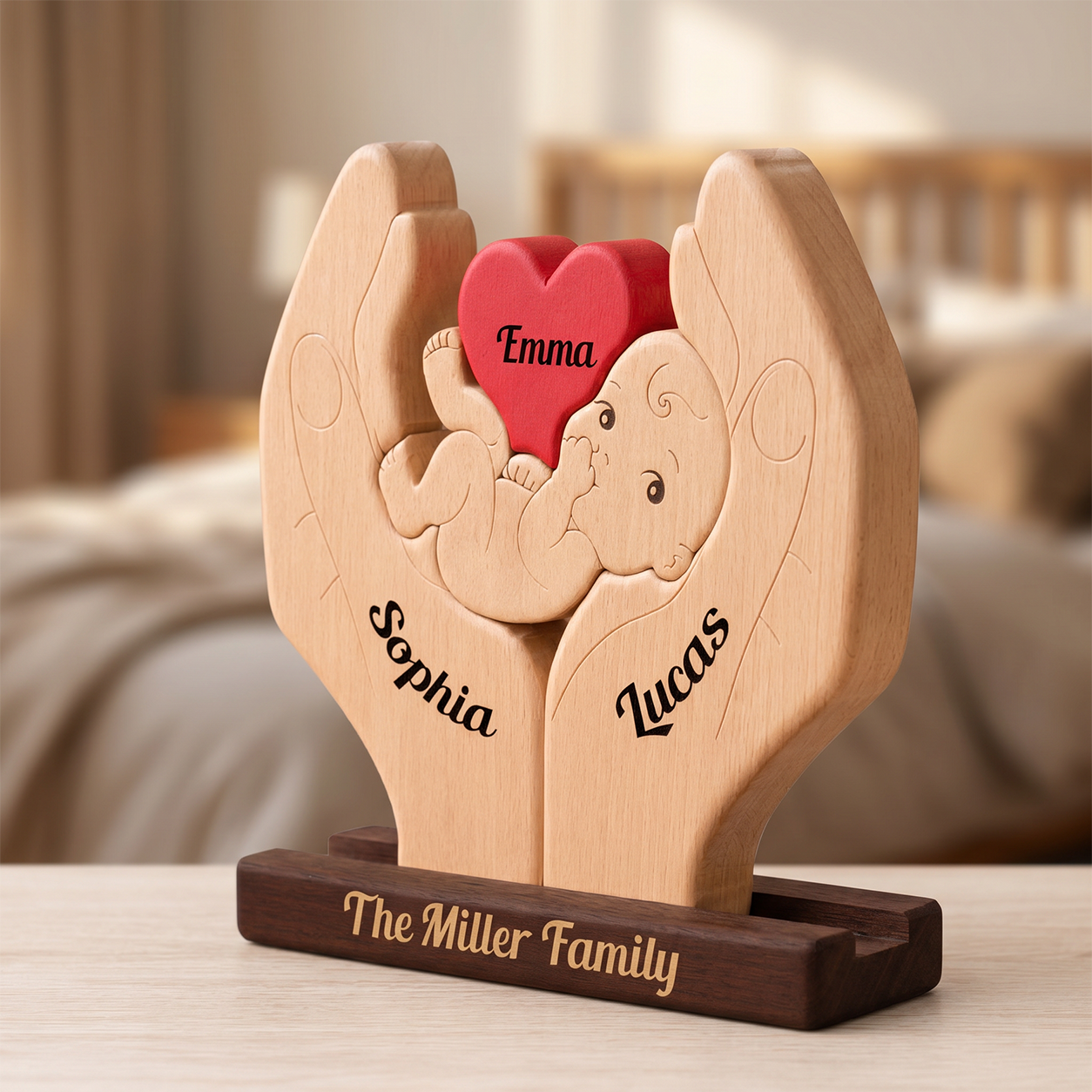 Personalized wooden baby keepsake plaque shaped like two hands holding a baby and a red heart, with engraved names