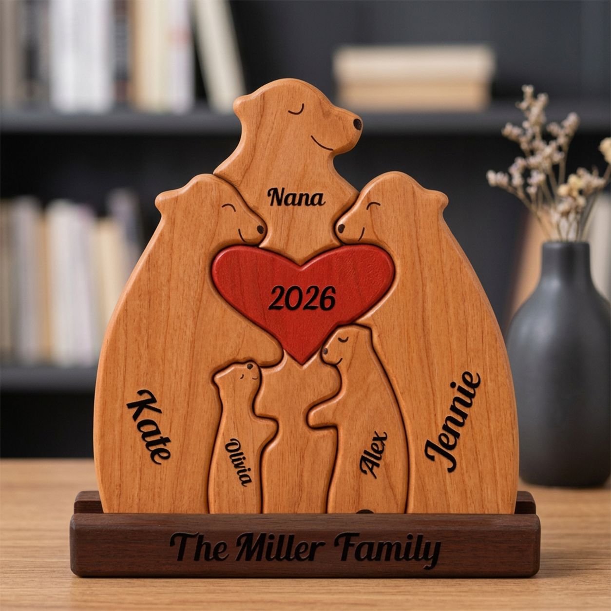 Wooden family sculpture with engraved names and year, placed on a wooden base.