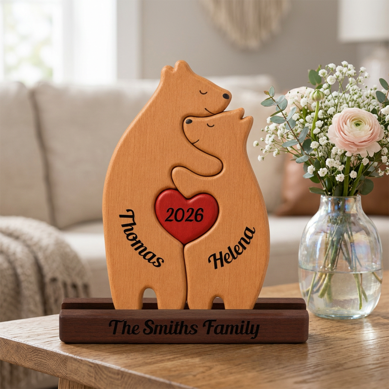 Wooden bear couple with names on a table with flowers in the background