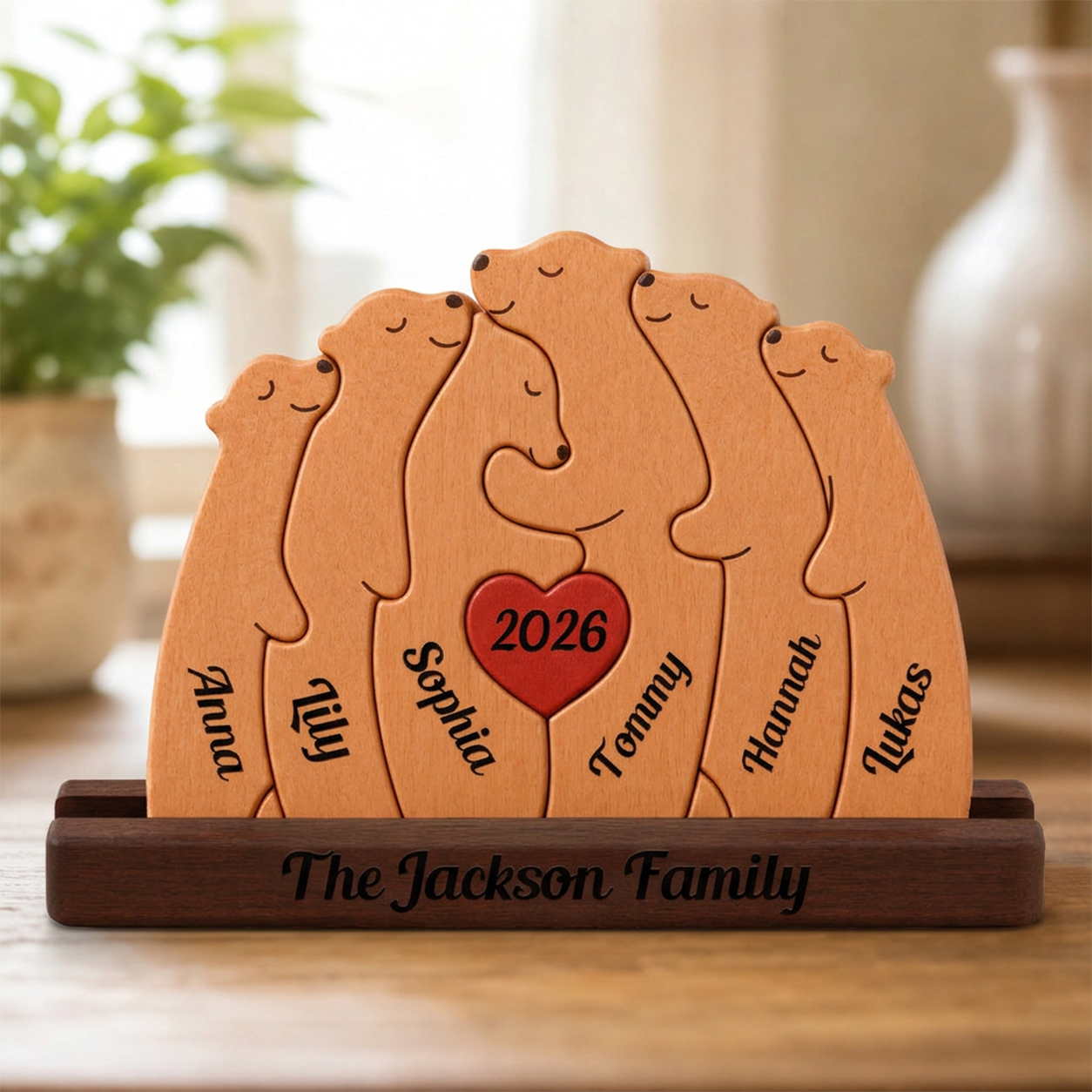 Wooden family plaque with engraved names and '2026' in the center, placed on a wooden surface.