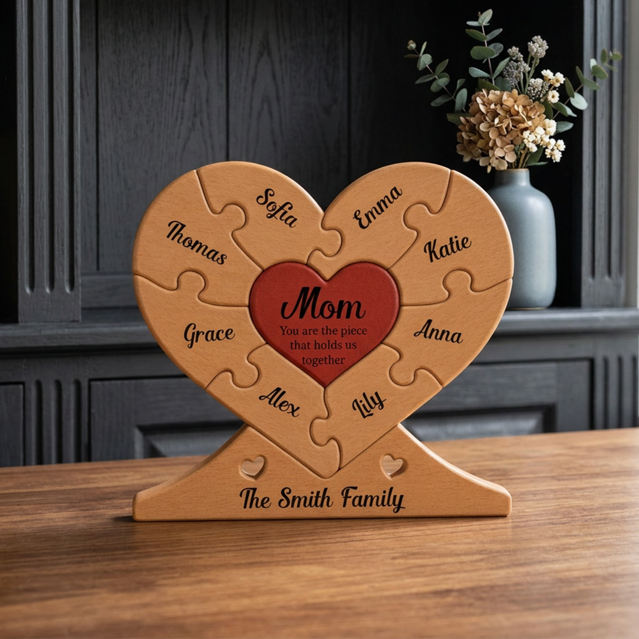 Wooden heart-shaped puzzle with names on a wooden table