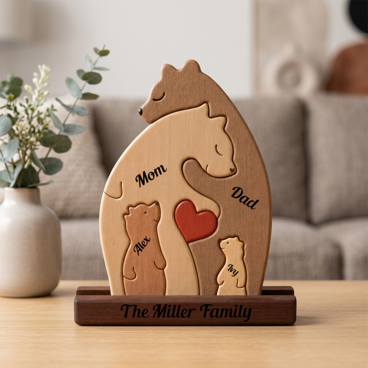 Wooden family figurine with 'Mom', 'Dad', and a heart on a stand, placed on a table.