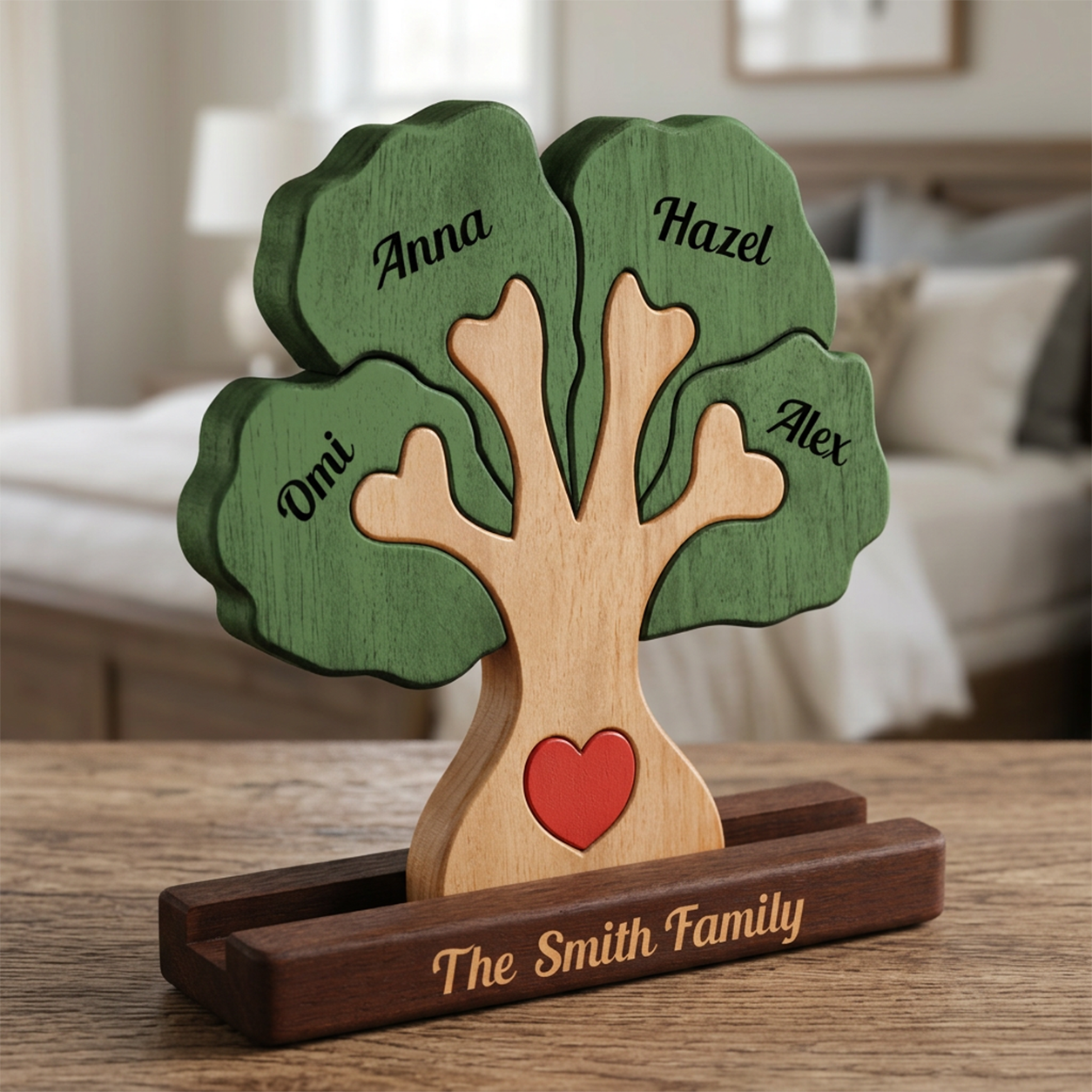 Personalized wooden family tree display on a dark wood base, with green leaves engraved with family names
