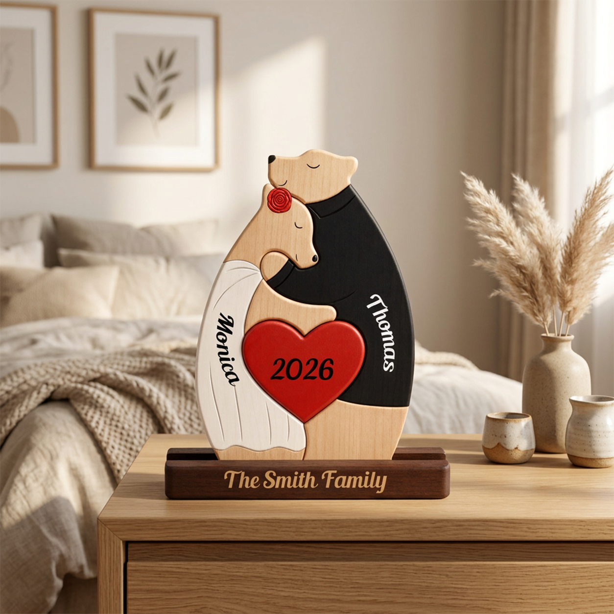 Personalized wooden bear sculpture on a dark wooden base, displayed on a bedside table in a softly lit bedroom. 